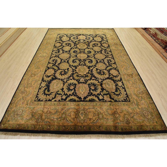 A traditional Agra rug is hand-knotted with fine wool on a cotton foundation. This area rug features a botanical design...