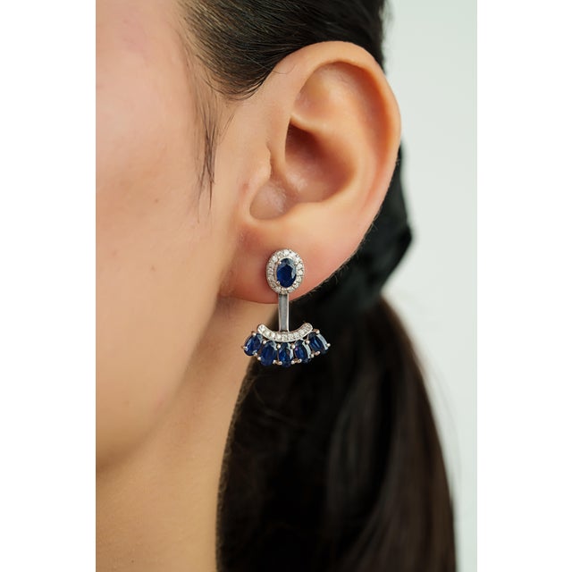 These Jacket earrings feature 4.16 carats of blue sapphires set in 14K white gold. The sapphire measuring 5.8 x 4, 3.2 x 5...