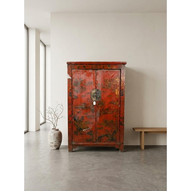 The exterior is finished with a distressed, aged crimson red lacquer. The front panels and outer borders are heavily...