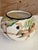 A charming vintage hand-painted ceramic bowl or cachepot featuring playful cockatoos perched among tropical foliage. The...