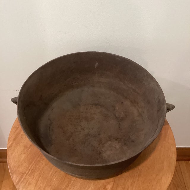 This Antique Large and Heavy Cast Iron Three-Footed Cauldron/Bean Pot with handles is a unique and rare piece of...
