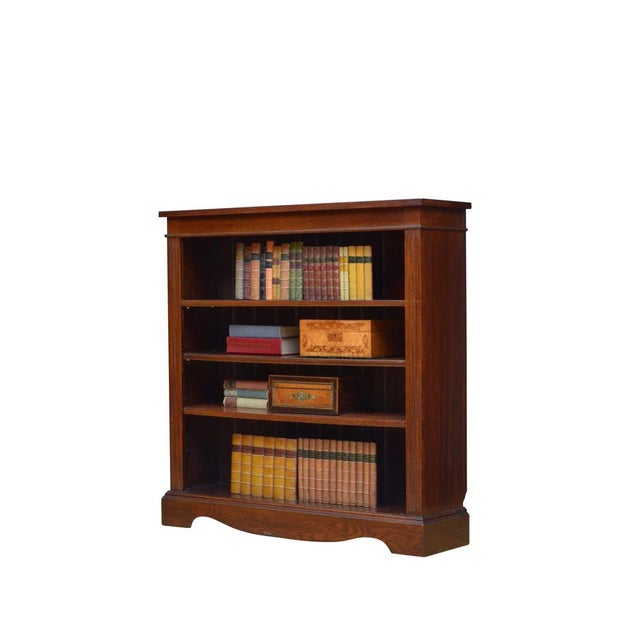 K0616 simple and elegant victorian bookcase in solid oak, having oversailing top above a shallow frieze and three height...