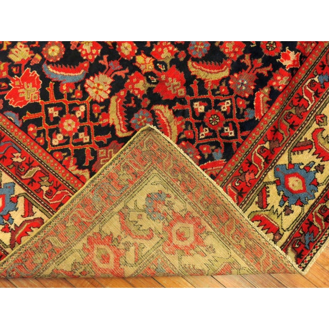 Gallery size Persian Malayer rug with an all-over repetitive design on a navy ground. Measures: 5'6” x 11'7”.