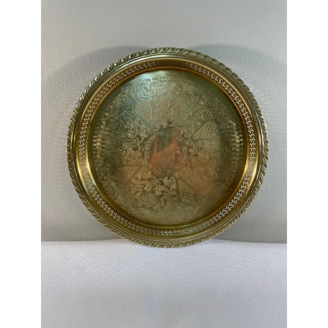 A fine Round Brass Serving or Gallery Tray with a raised reticulated rim and etched center. Circa 1970s. Made by Oneida....