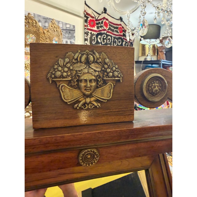 Late 1900s antique Empire dressing mirror. Fashioned of walnut and bronze finish metal. The mirror is in excellent antique...