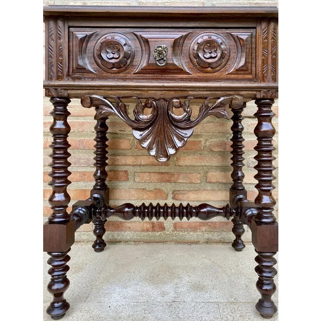 20th century pair of solid carved French nightstands with turned columns and stretcher. It has one carved drawer with...