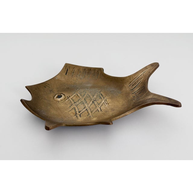 Mid-Century Modern 1950s solid brass dish in modernist fish form. A versatile size, perfect for rings, as an ashtray, or...