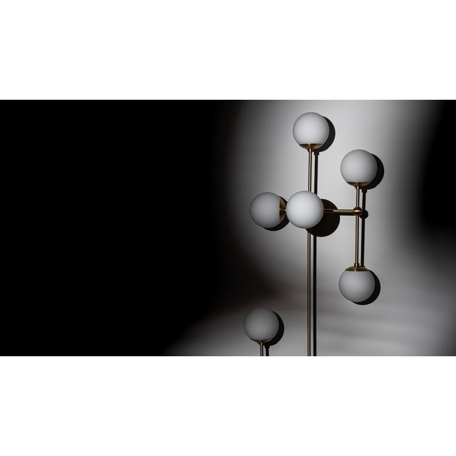 Armstrong captures a sense of movement. Forms connect with spontaneous energy, punctuated by glass spheres. Linear...