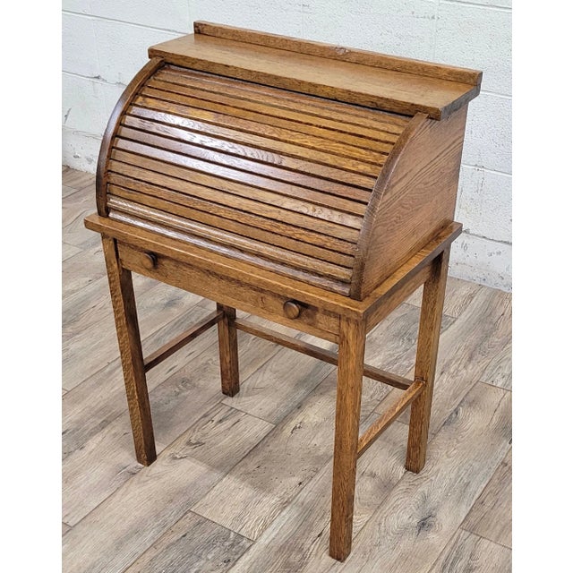 This is a gorgeous antique children’s secretary roll top desk, likely from the early 1900s. Features a functional roll...