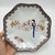 A set of four Japanese porcelain plates featuring . The rims are decorated with a continuous painted border of heart-...
