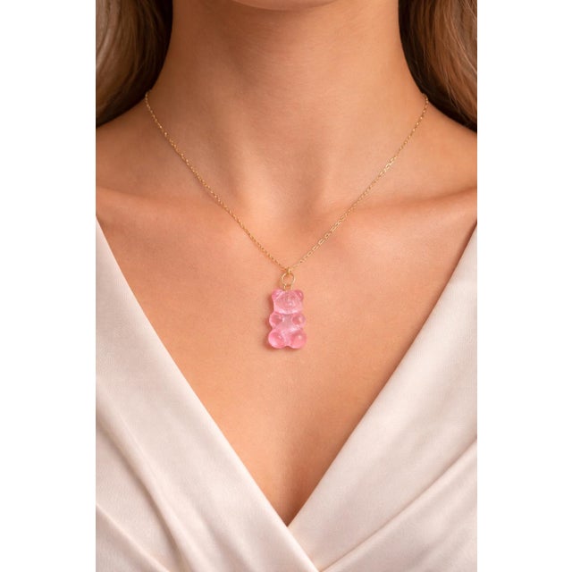 Playful and eye-catching, this 14K yellow gold pendant necklace features an adorable gummy bear charm crafted from pink...