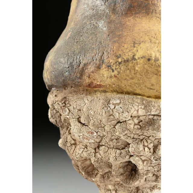 Dennis W. Smith San Antonio, Texas A raku fired organic form chalice, the mottled yellow/gold waisted bowl raised on...