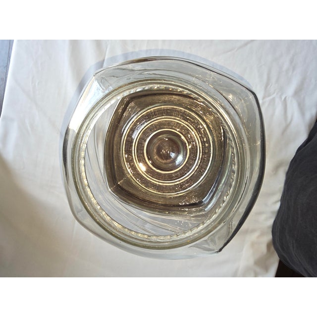 Wonderful antique peanut jar with special wood base that fits the jar. The jar has a special bottom so it is made to not...
