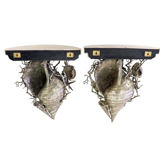 Pair of Maitland Smith silver conch seashell wall shelves. Sculpted metal in the shape of conch shells with starfish,...