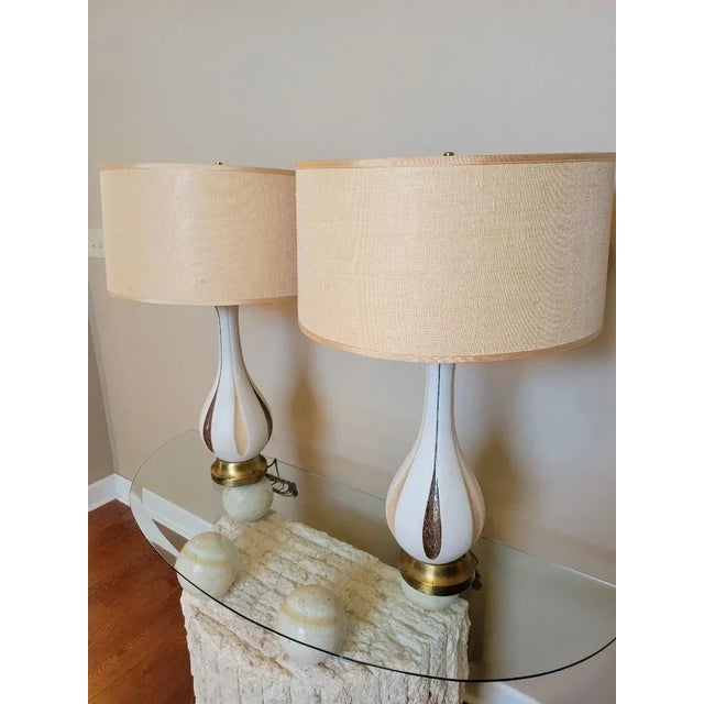 Fantastic pair of mid-century modern table lamps. Styled as Quartite Creative Corp made lamps. The pair has textured cream...