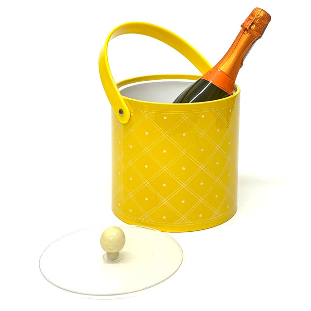 Yellow ice bucket. This is an eccentric vinyl and lucite bright yellow and white lidded ice bucket in a cylindrical shape...