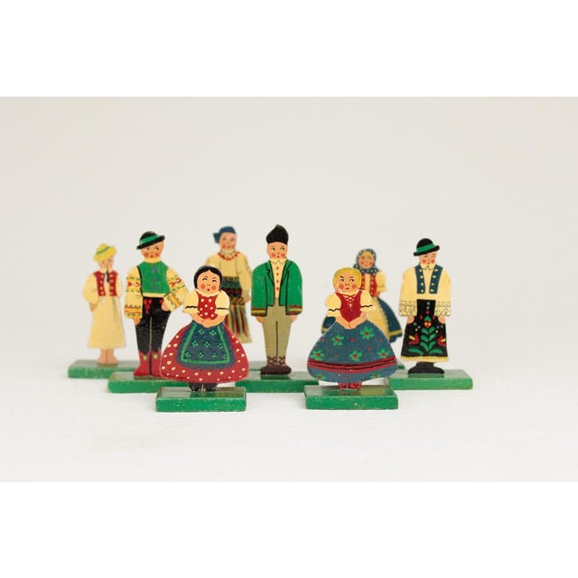 Flat Figures A rare set of eight standing wooden figures in traditional Transylvanian costumes from Romania. Each figure...