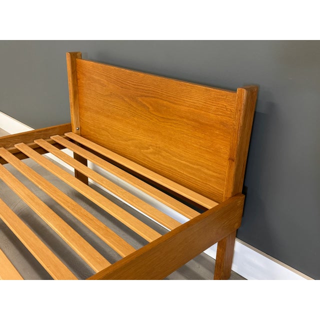 A modern solid oak twin size platform bed in excellent condition. Clearance under the side rails is 10”. Footboard is 18”...