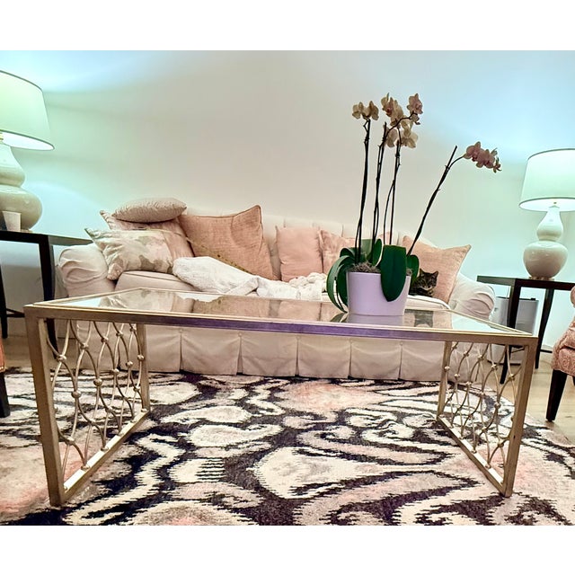 Elegant Ethan Allen glass-top coffee table featuring a beautifully detailed antiqued brass lattice base with sculptural...