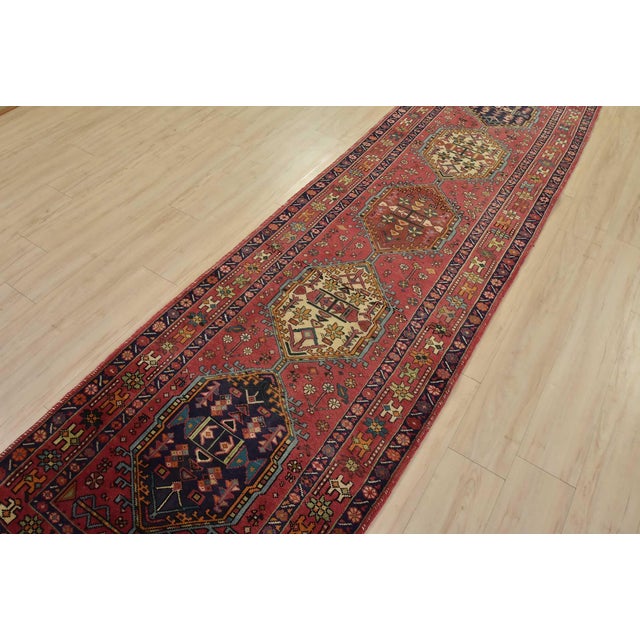 An authentic semi-antique tribal Karajeh runner hand-knotted with fine wool and natural dyes. This nomadic oriental rug...