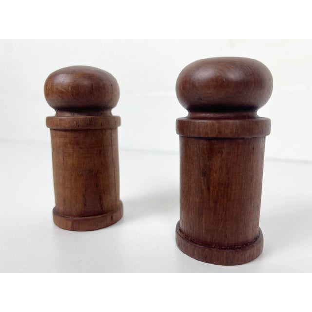 Pair of vintage pillar shaped Danish Modern salt and pepper shakers in solid teak wood. Origin: Denmark Year: 1960s Style:...