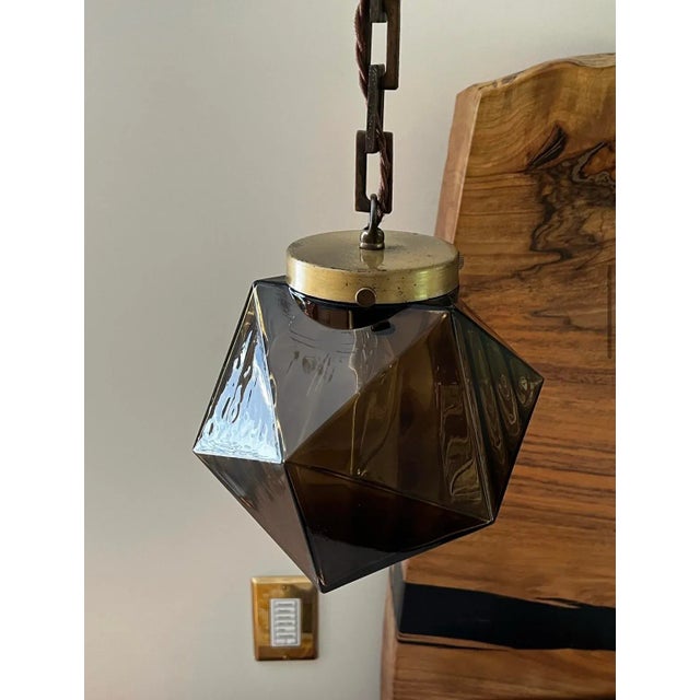You are looking at a very cool pair of 1960s high style smoked glass gem fixtures with darkened brass fitting and chain....