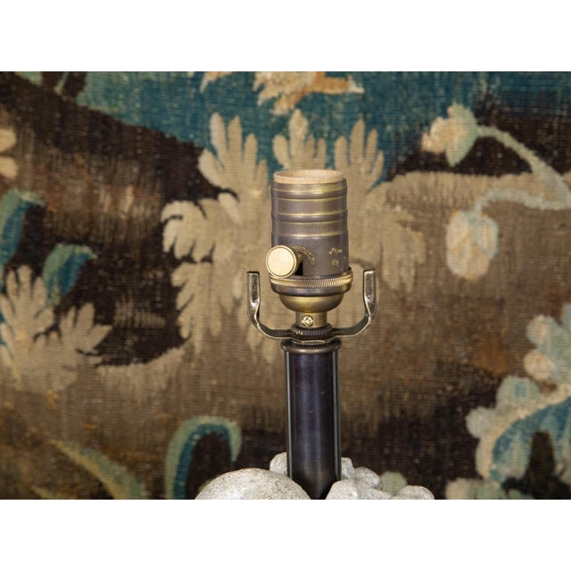 A French carved stone table lamp from the Mid-20th Century, depicting a fruit bowl on a tall pedestal, wired for the USA....