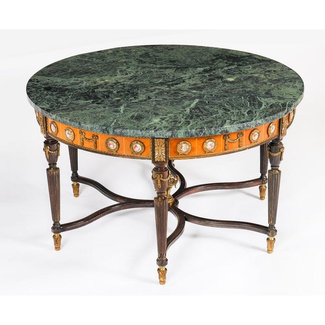 This is an exquisite ormolu-mounted walnut and king wood marble top coffee table, circa 1950 in date and by the renowned...