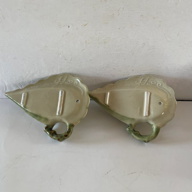 A Pair Of Hull Pottery Wall Pocket Woodland Floral in shades of soft Pink, White and Green. Each measures 8" in height....