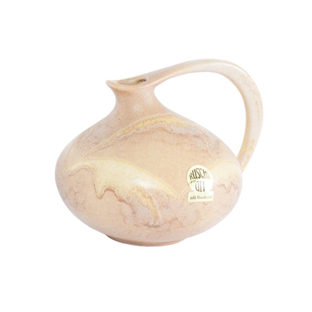 A West German ceramic pitcher designed by the German ceramicist Kurt Tschorner for Ruscha Keramik. This pitcher has a...