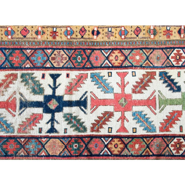 An iconic late 19th-century Kuba runner from Azerbaijan, handwoven in richly dyed wool, with a mesmerizing central field...