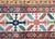 An iconic late 19th-century Kuba runner from Azerbaijan, handwoven in richly dyed wool, with a mesmerizing central field...