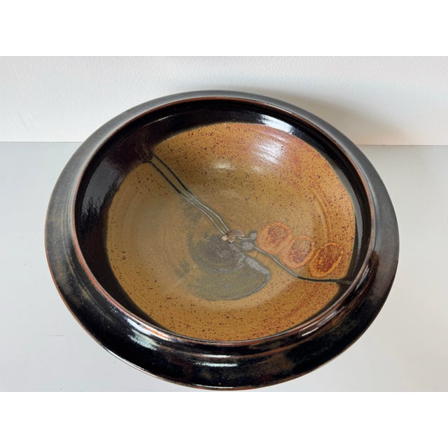 Striking large 1980’s handmade studio pottery bowl featuring a sculptural pedestal base and beautifully layered earth-tone...