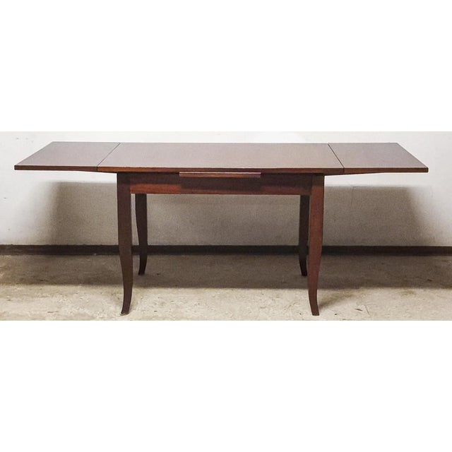 Polyester-polished table with two extensions that fit concealedly under the table top. Handcrafted in the early 2000s with...