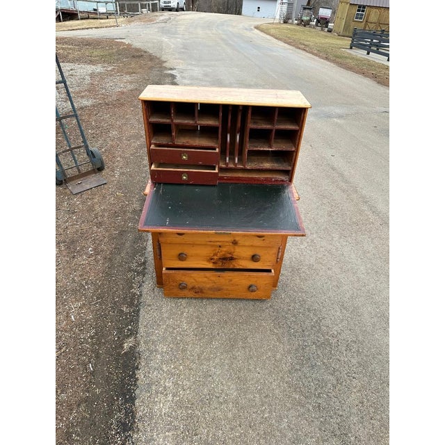 Very attractive and useful antique desk. The wooden nails can be seen where the top attaches to the body of the piece....