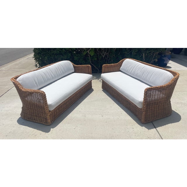 Gorgeous pair of woven rattan sofas, attributed to the Wicker Works brand (no labels). Designed in the California coastal...