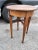 This is an adorable little antique side table! The rich brown and amber colors of the wood blend together in the grain and...