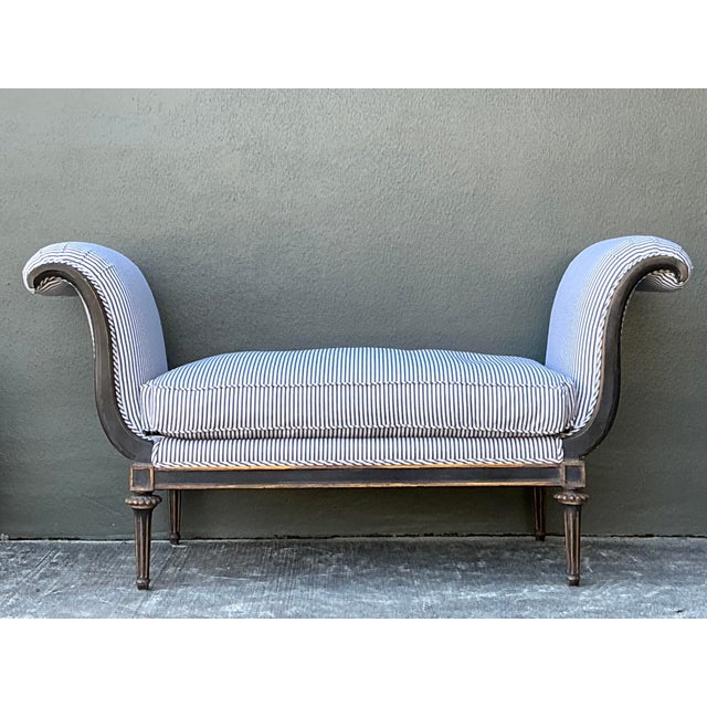 This elegant vintage bench captures the timeless grace of French Directoire design with its dramatic scrolled arms and...