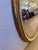Pretty oval cream painted and gold leaf vintage wall mirror.