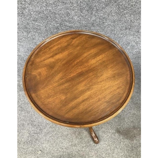 A timeless accent piece with graceful proportions and rich mahogany warmth. This authentic vintage Henkel Harris plant...