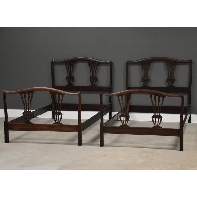 A pair of antique twin sized beds made of solid mahogany. Made in USA. Circa 1920’s. Excellent condition. Footboard is...
