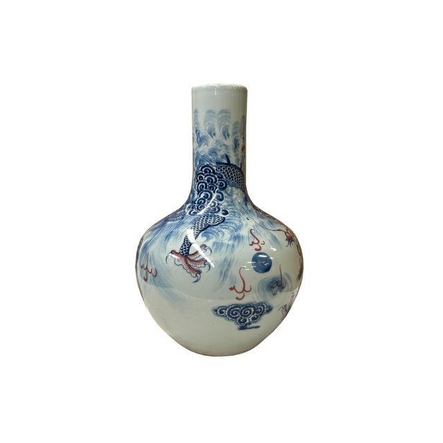 This striking Chinese porcelain "heavenly bottle" vase (tianqiuping) features a globular body and a straight cylindrical...