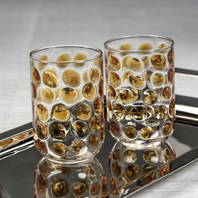A fresh twist on everyday glassware, this borosilicate tumbler catches the light with its softly dimpled texture and airy,...