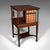 This is an antique revolving bookcase. An English, walnut rotating novel library, dating to the Edwardian period, circa...