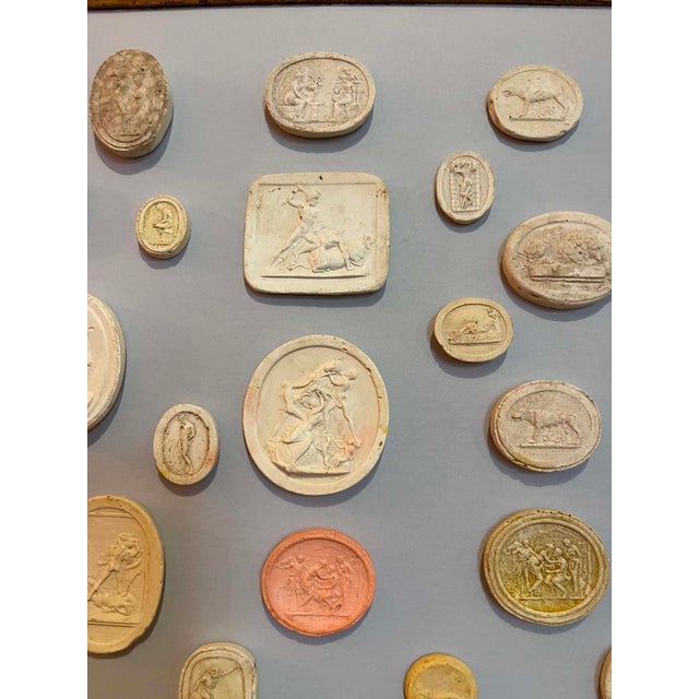 Immerse yourself in the enduring allure of classical antiquity with this truly unique collection of framed intaglios....