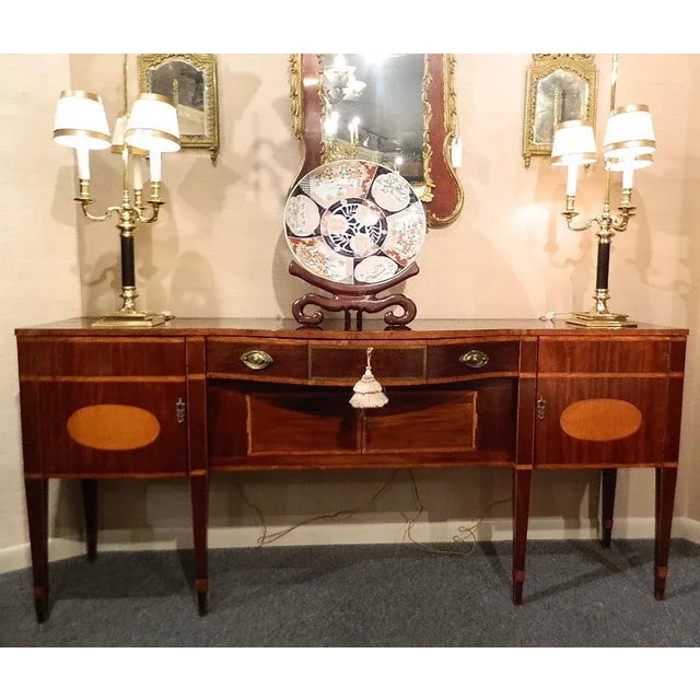 Late 18th Century Rare Size Regency sideboard with satinwood inlaid top and tapered spade legs. The rectangular top banded...