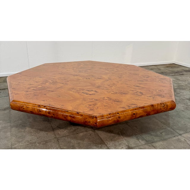 A refined Italian coffee table from the 1970s, distinguished by its octagonal form and rich burl wood veneer. The top...