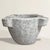 An 18th-century French carved marble mortar, rich with history and softened by centuries of use, its surface worn smooth...