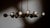 Sparks of light trail brass lines in a circular formation. Radiating out from a spherical nucleus, ten sprightly rods...