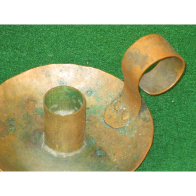 A pair of hand-hammered Arts and Crafts Copper Candle Holders made in the USA between 1900-1960. The candle holders...